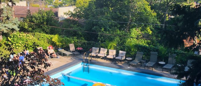outdoor swimming pool, complete with comfortable lounge chairs, lush greenery, and scenic views.